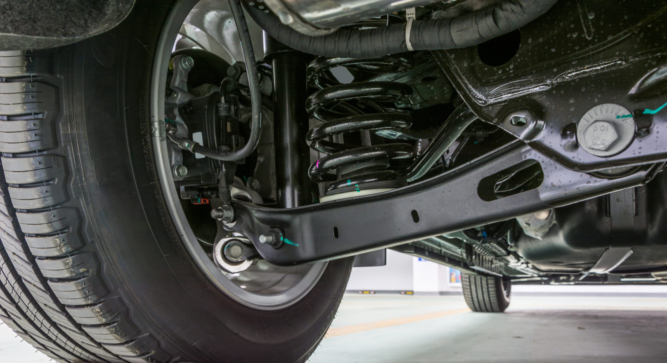 Technical photo. The structure of the modern car. Rear suspension. Shock absorber. Spring suspension.