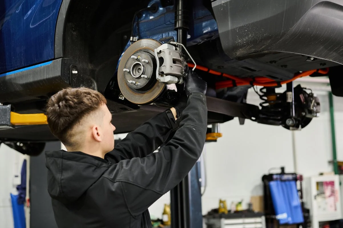 mechanic repairing brakes in Greeley Colorado